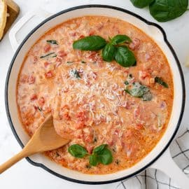 overhead shot of wooden spoon in pan of vodka cream sauce