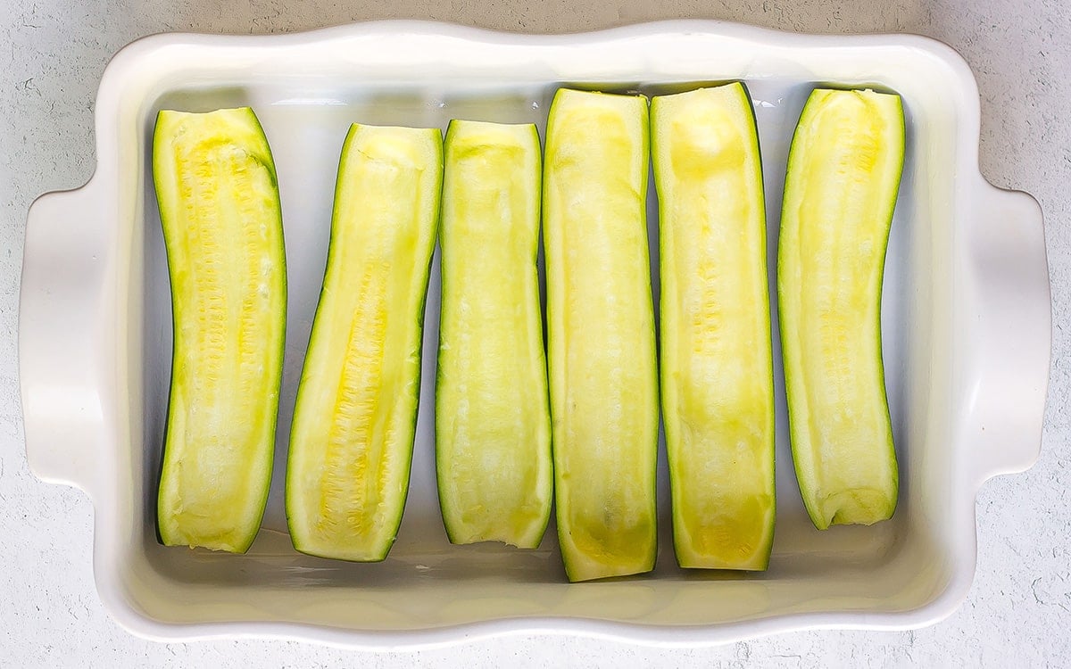 zucchini halves in a baking dish