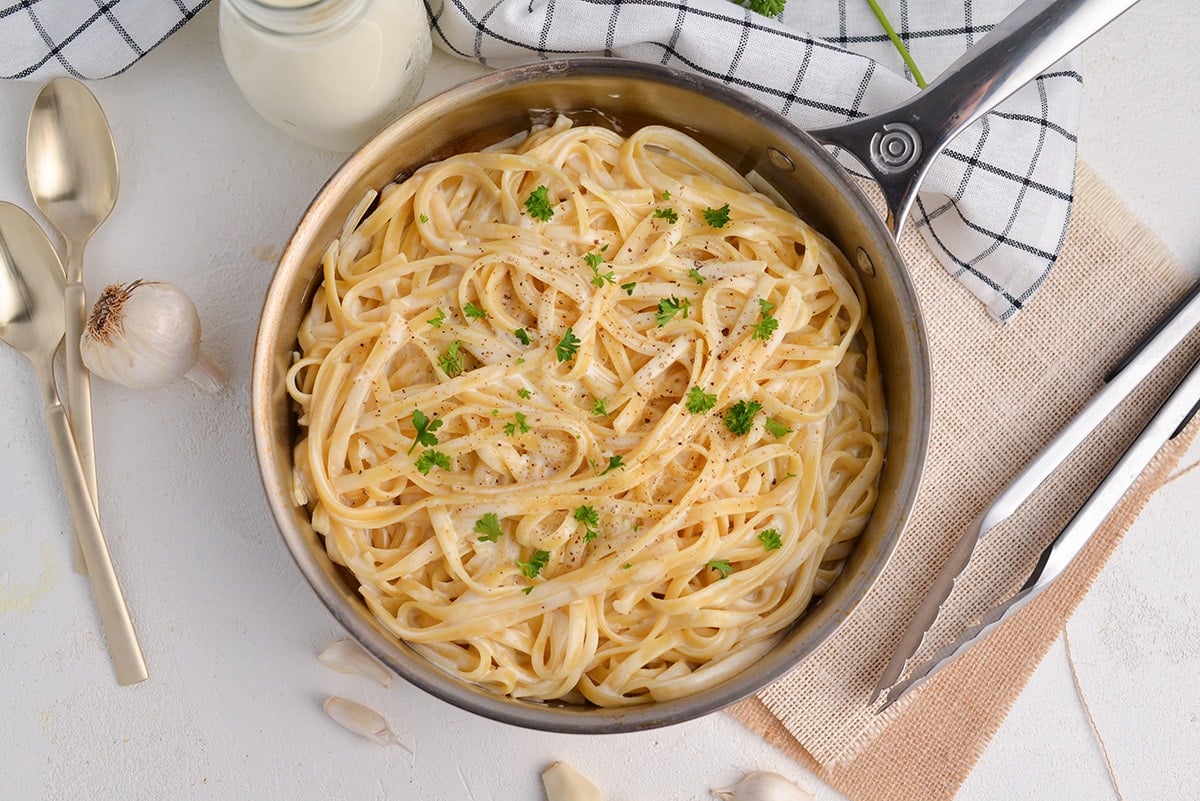 overhead of fettuccine alfredo in a skillet