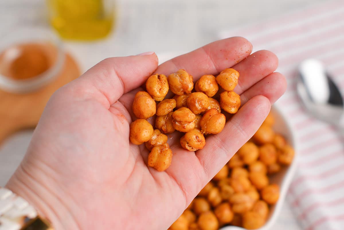 hand holding handful of air fryer chickpeas