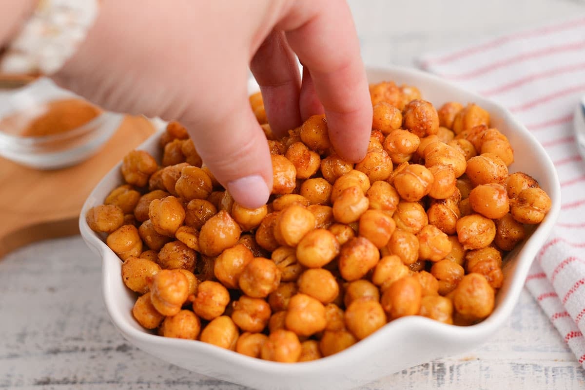 hand reaching into bowl of crispy chickpeas