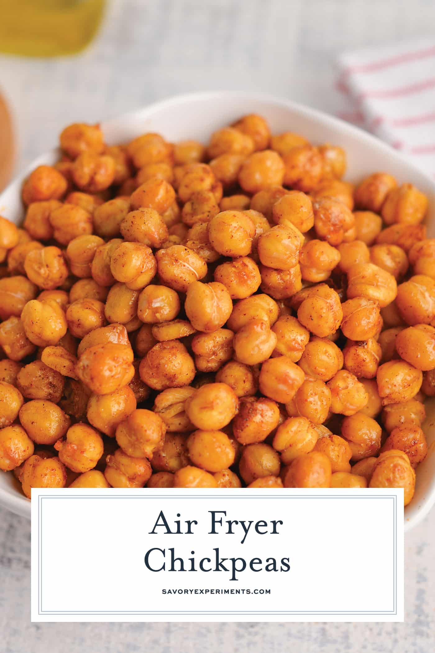 angled shot of bowl of air fryer chickpeas with text overlay for pinterest