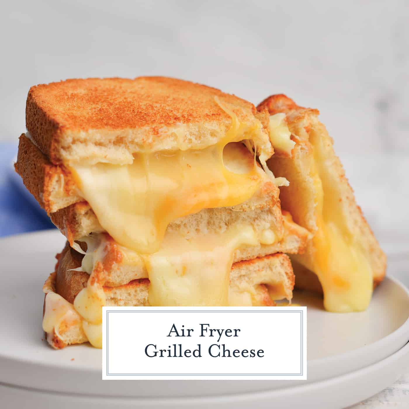stack of grilled cheese halves on a plate with text overlay for facebook