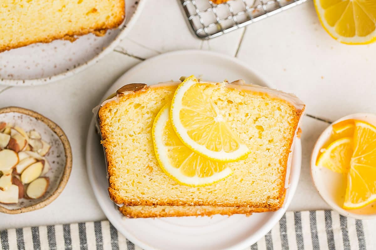 overhead shot of slice of lemon cake topped with lemon slices