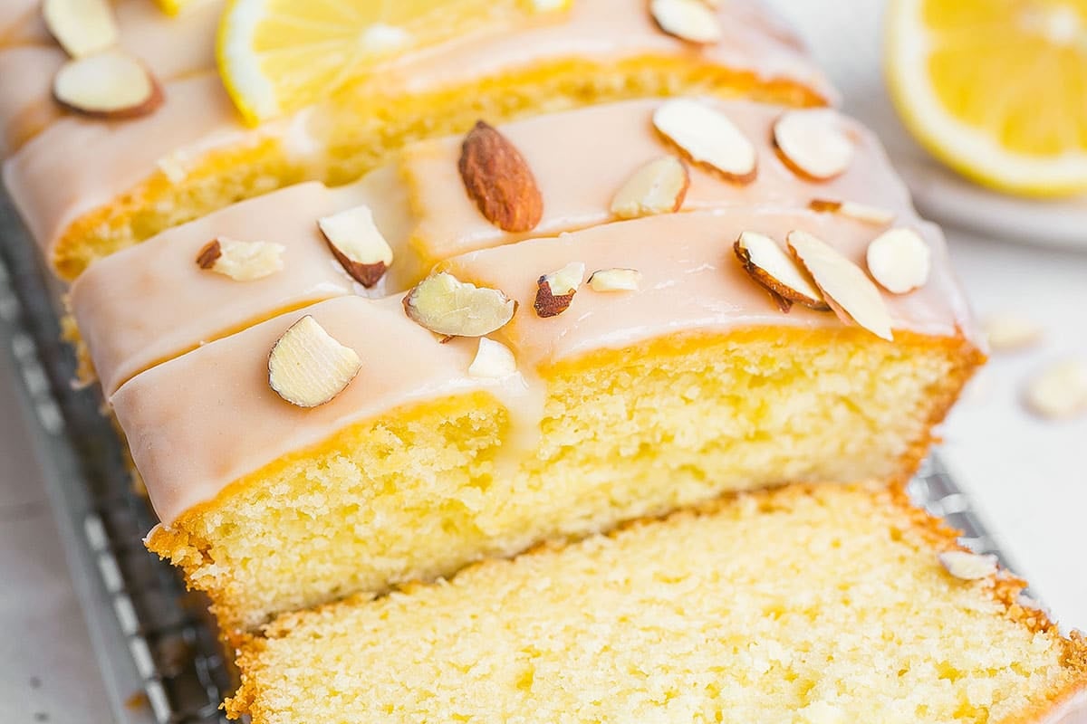 close up angled shot of sliced almond loaf cake