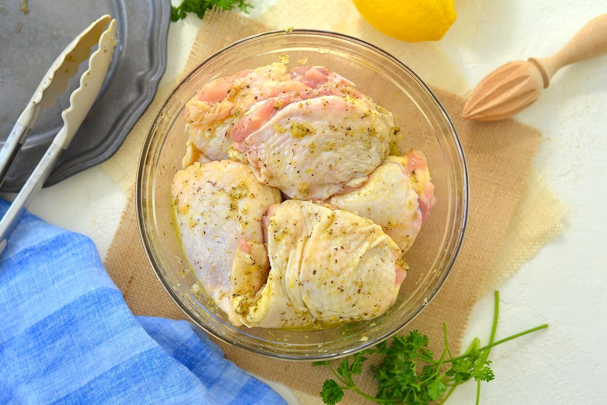chicken thighs marinating in a bowl