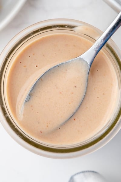 overhead shot of spoon in jar of bloomin onion sauce