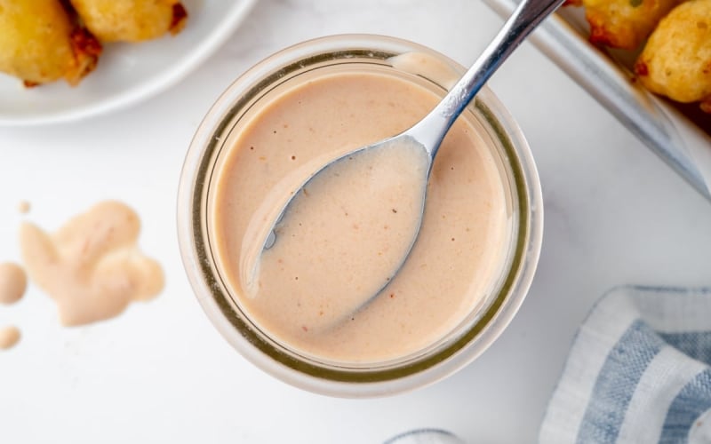 overhead shot of spoon in jar of bloomin onion sauce