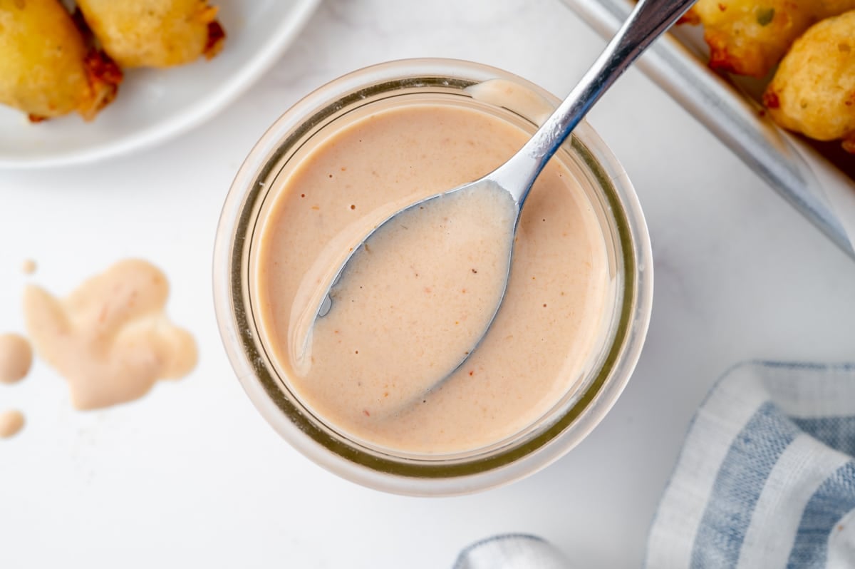 overhead shot of spoon in jar of bloomin onion sauce