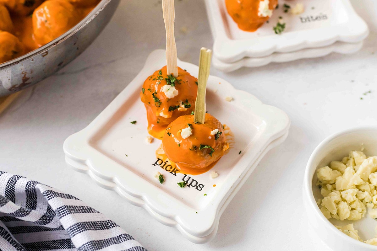 angled shot of two meatballs on a small plate