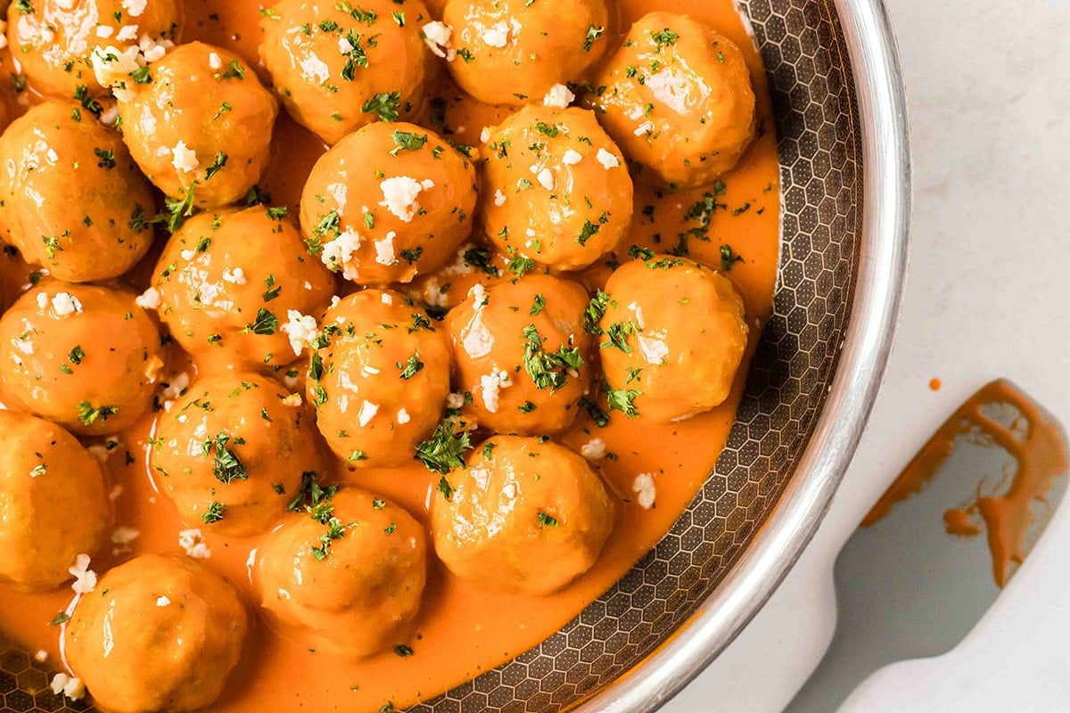 close up of buffalo chicken meatballs in a pan