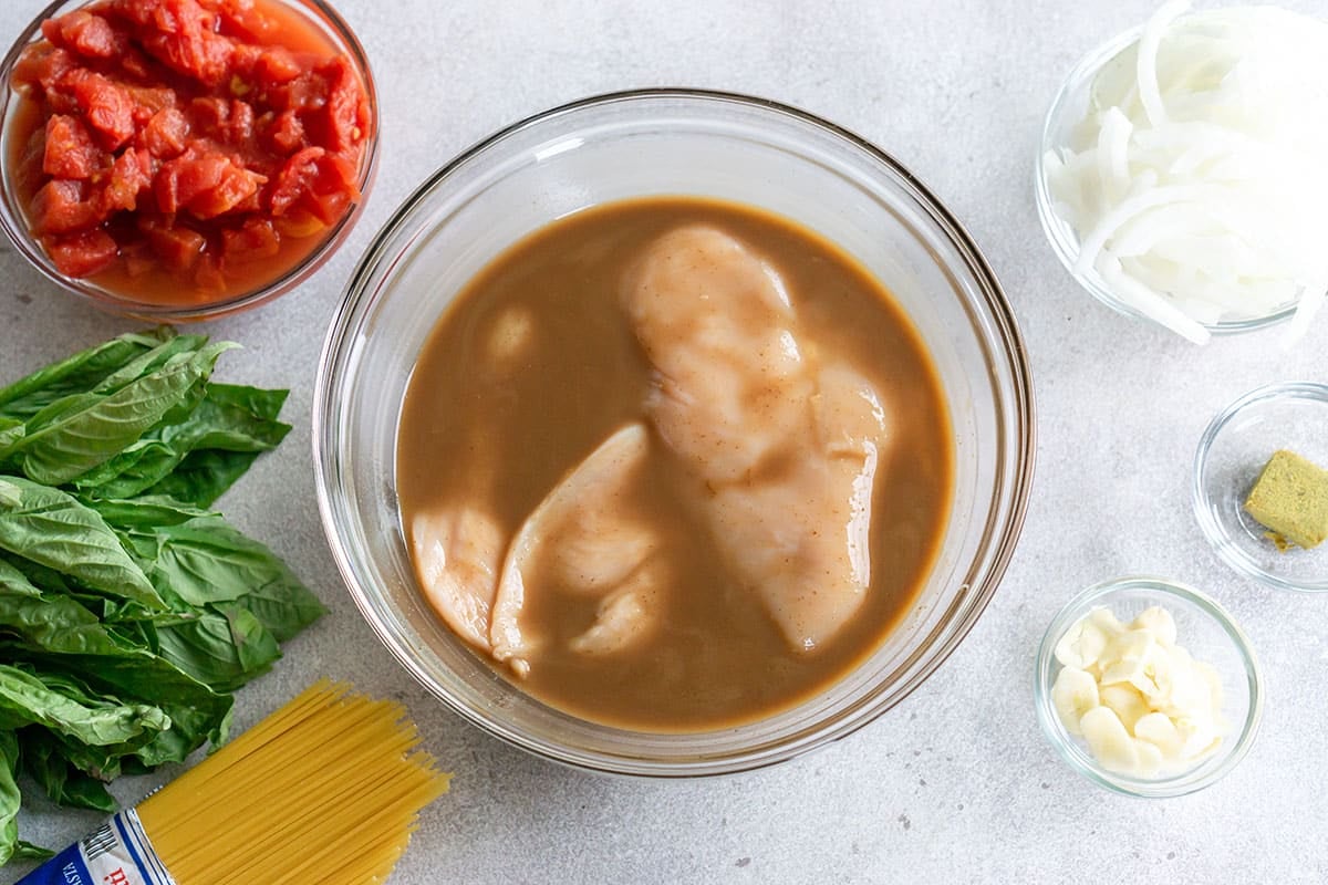 chicken marinating in bowl