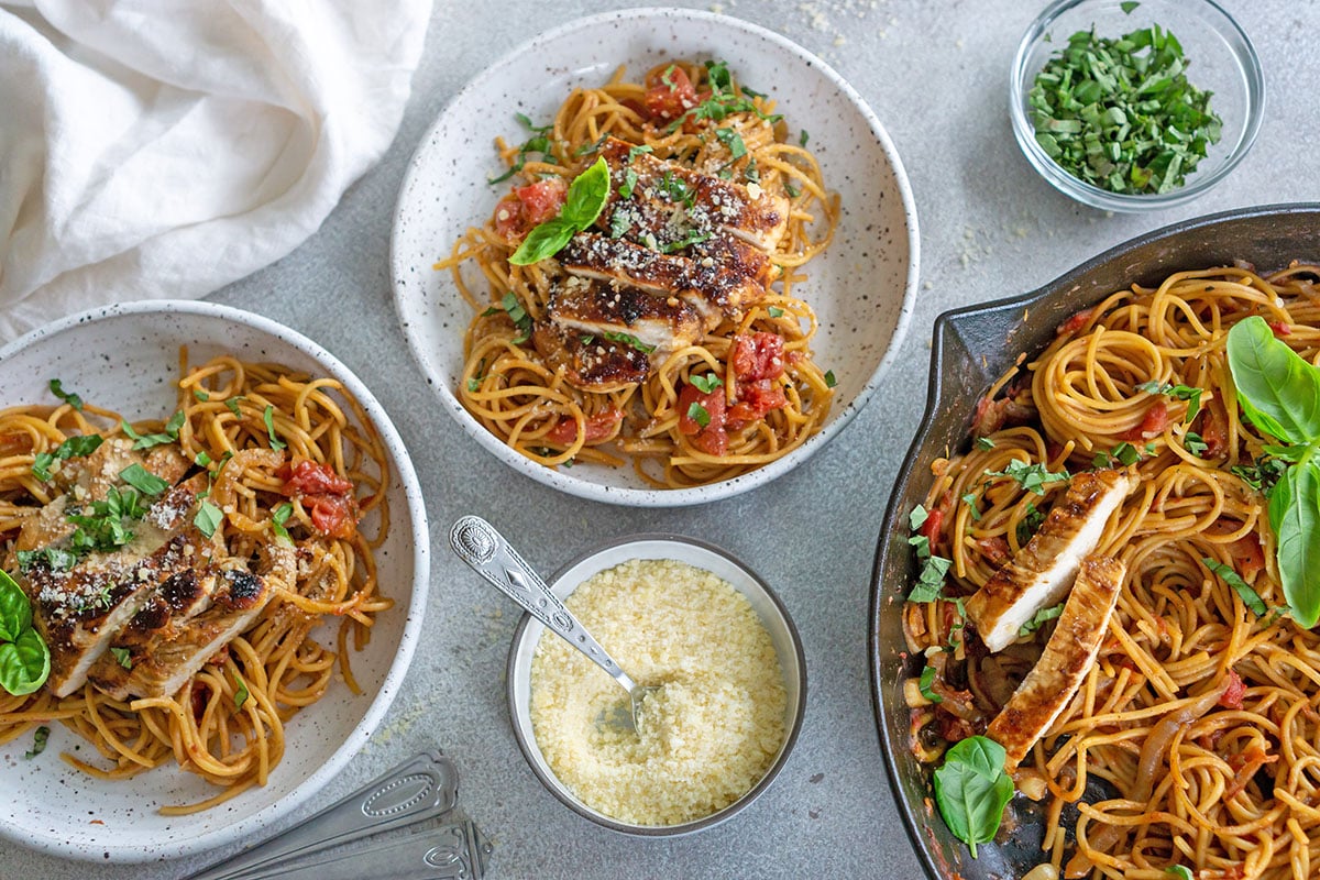 overhead shot of two bowls of pasta with chicken