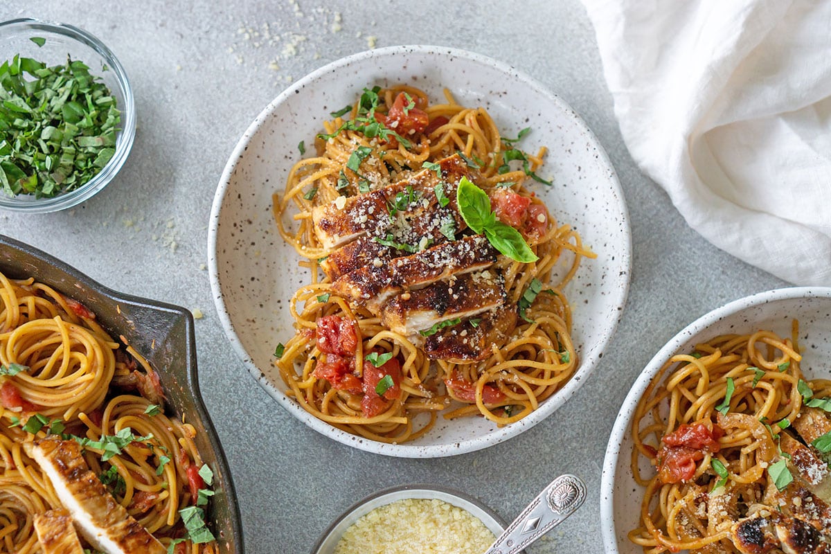 overhead shot of chicken bruschetta pasta in bowl