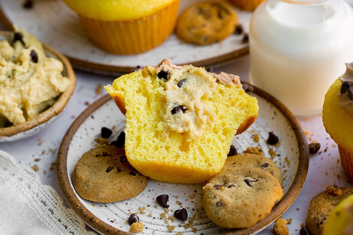 angled shot of stuffed cookie dough cupcake cut in half