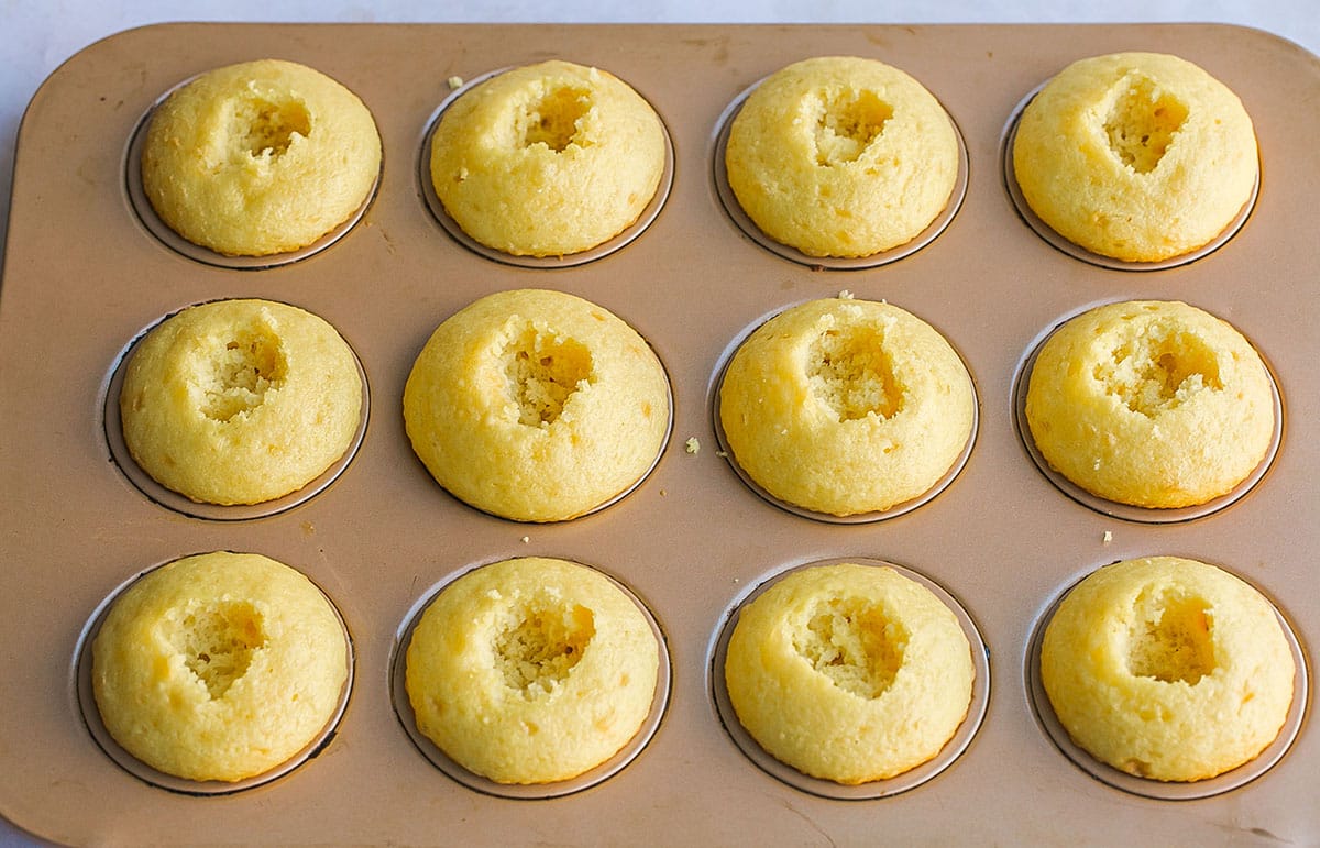 holes cut in middle of baked cupcakes