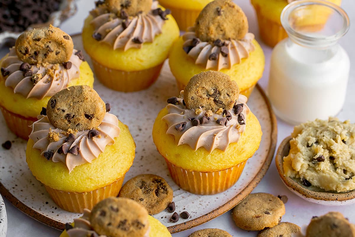 five stuffed cookie dough cupcakes on a plate