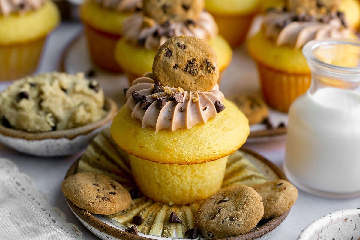 cookie dough stuffed cupcake on a plate with cookies