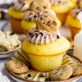 straight on shot of stuffed cookie dough cupcake on a plate