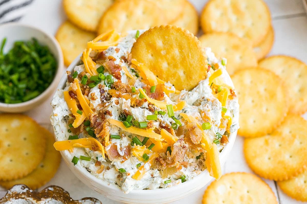 close up angled shot of recipe for crack dip in a bowl with a cracker