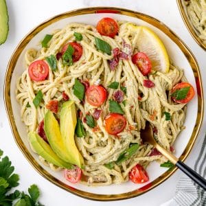 plate of creamy avocado pasta sauce with a fork