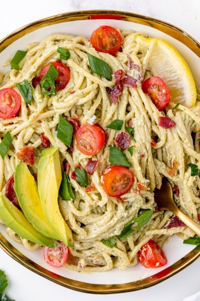 plate of creamy avocado pasta sauce with a fork