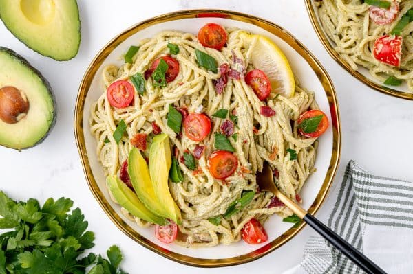 plate of creamy avocado pasta sauce with a fork