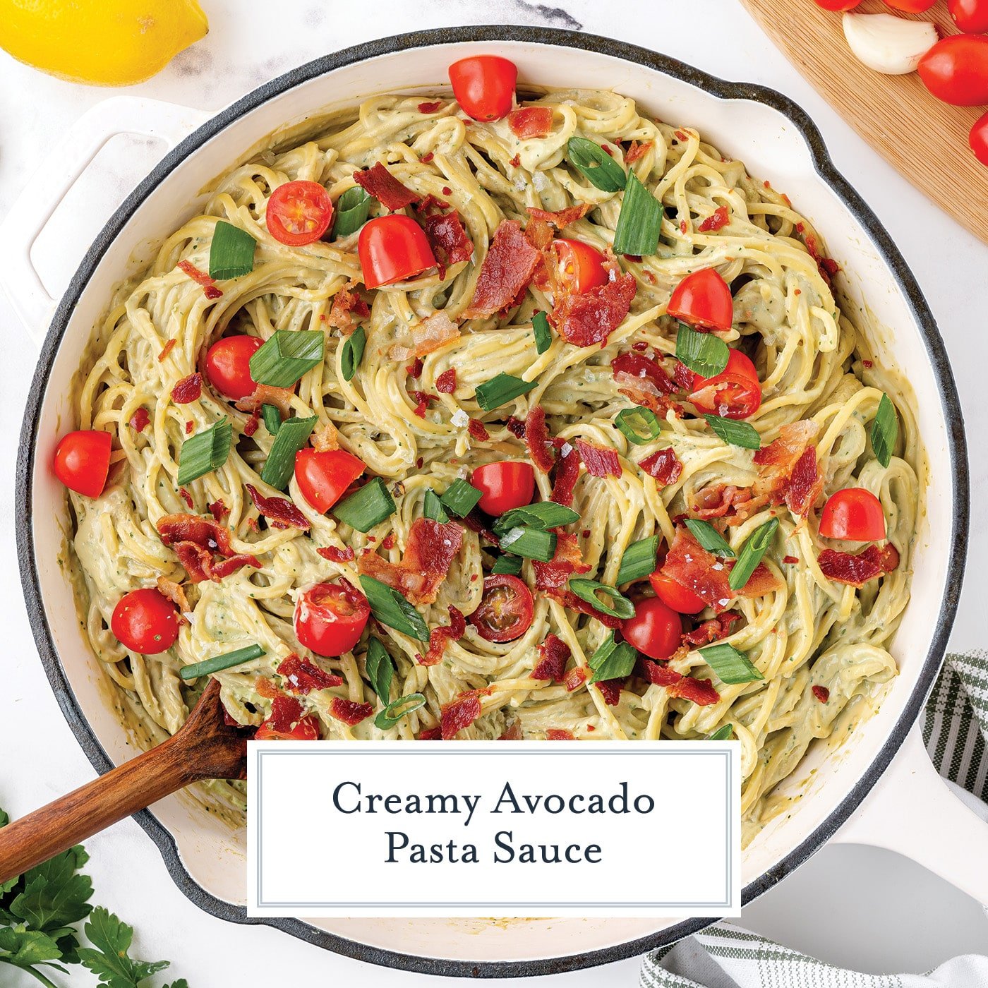 overhead shot of cream avocado pasta sauce in pan with text overlay for facebook