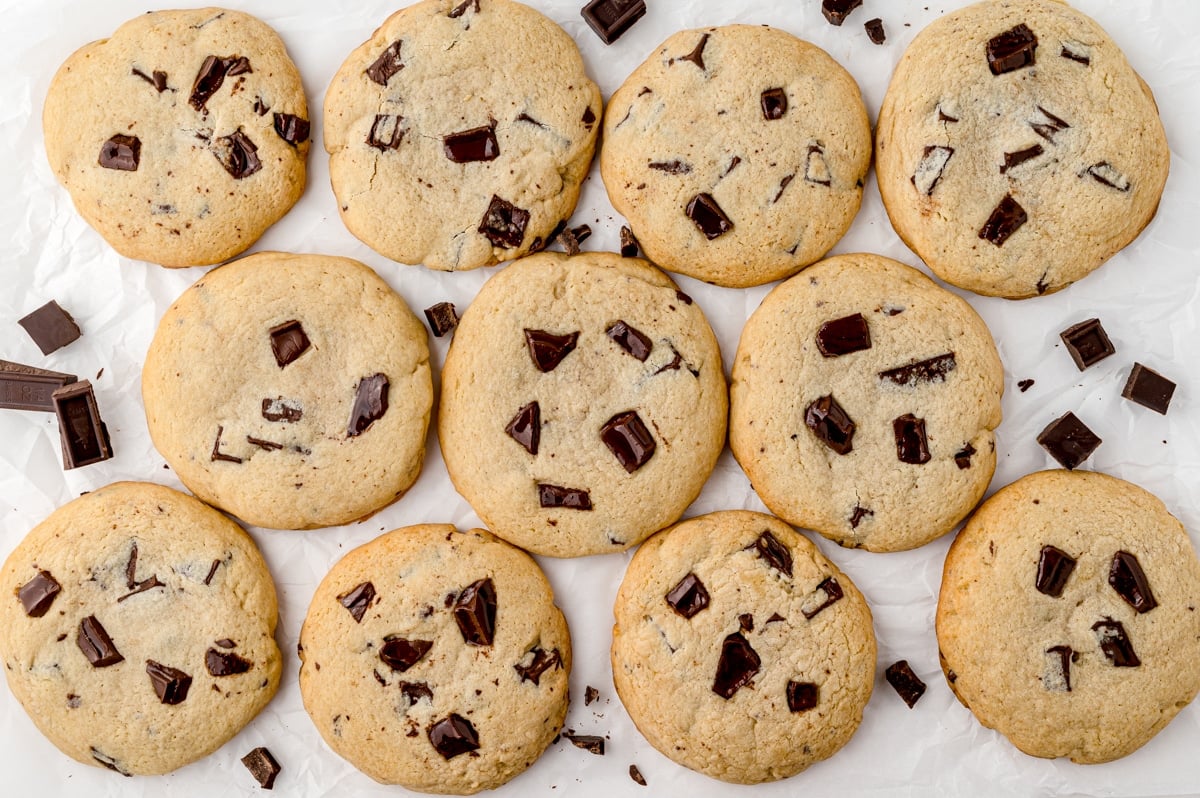 several cookies on parchment with chocolate chunks