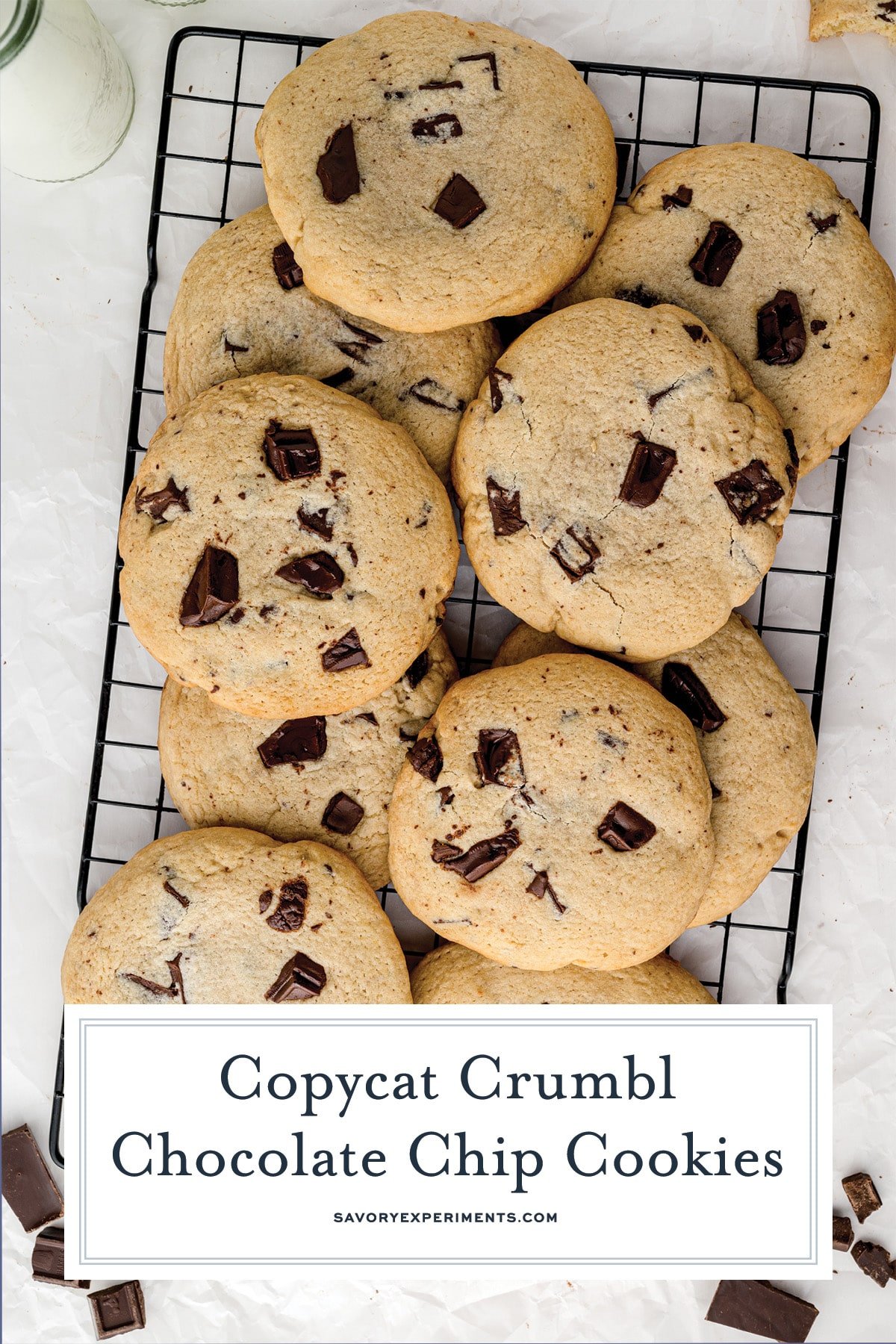 pile of chocolate chunk cookies on a black wire rack