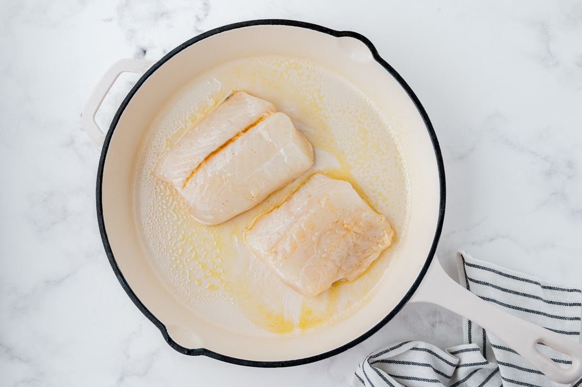 fish frying in a pan