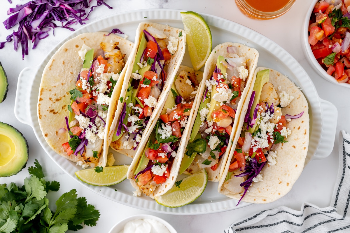 overhead shot of 5 fish tacos on a platter