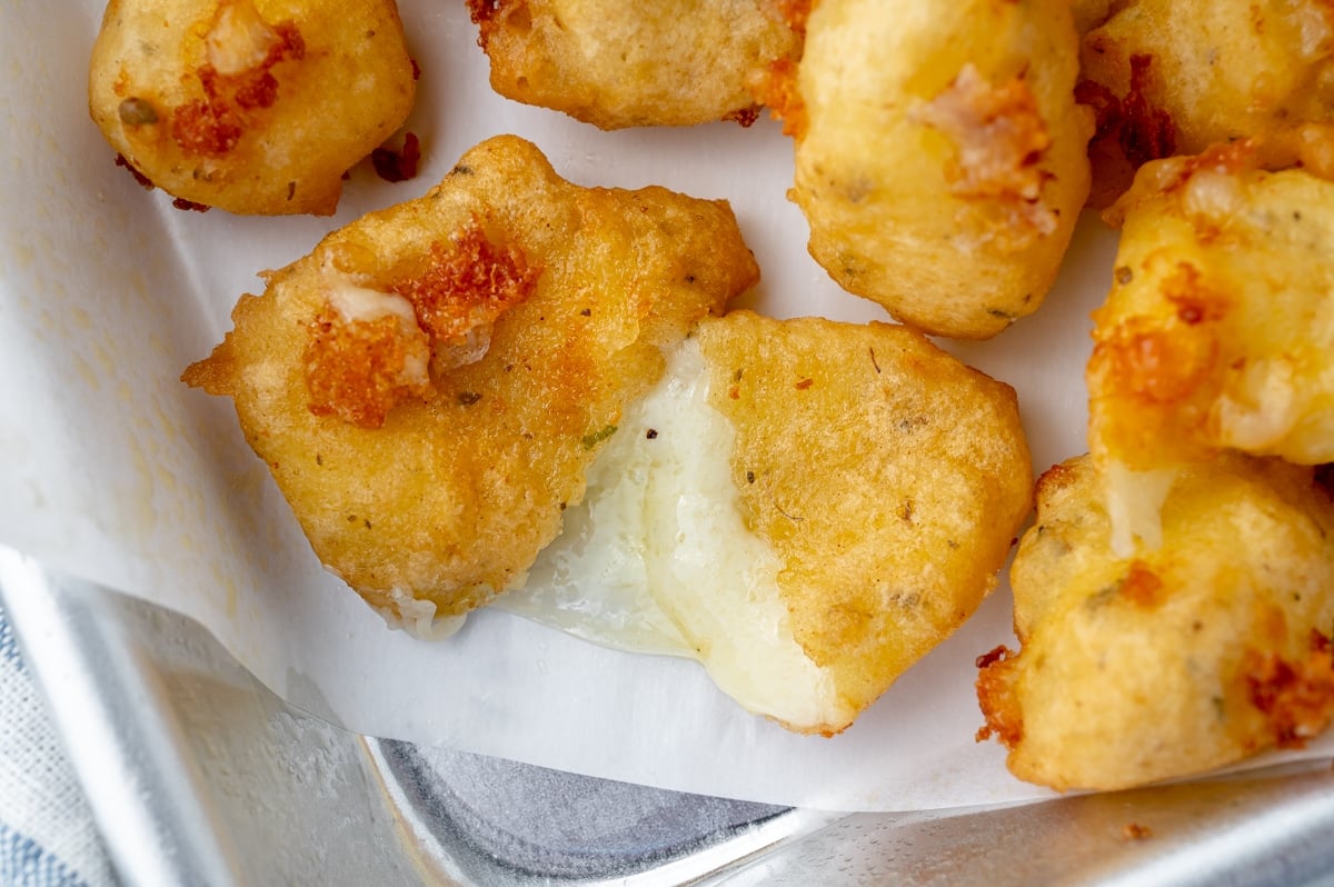 close up of fried cheese curd cut in half