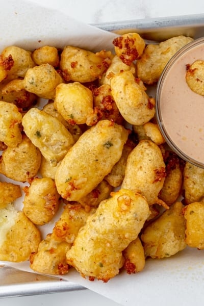 tray of fried cheese curds with dipping sauce