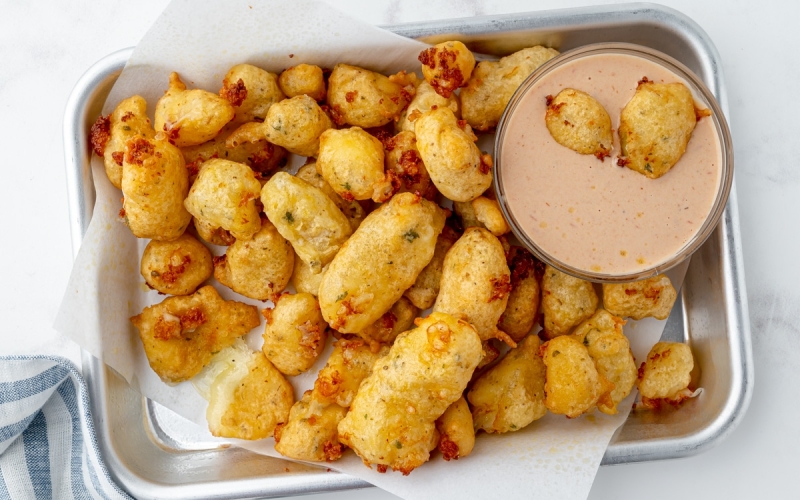 tray of fried cheese curds with dipping sauce