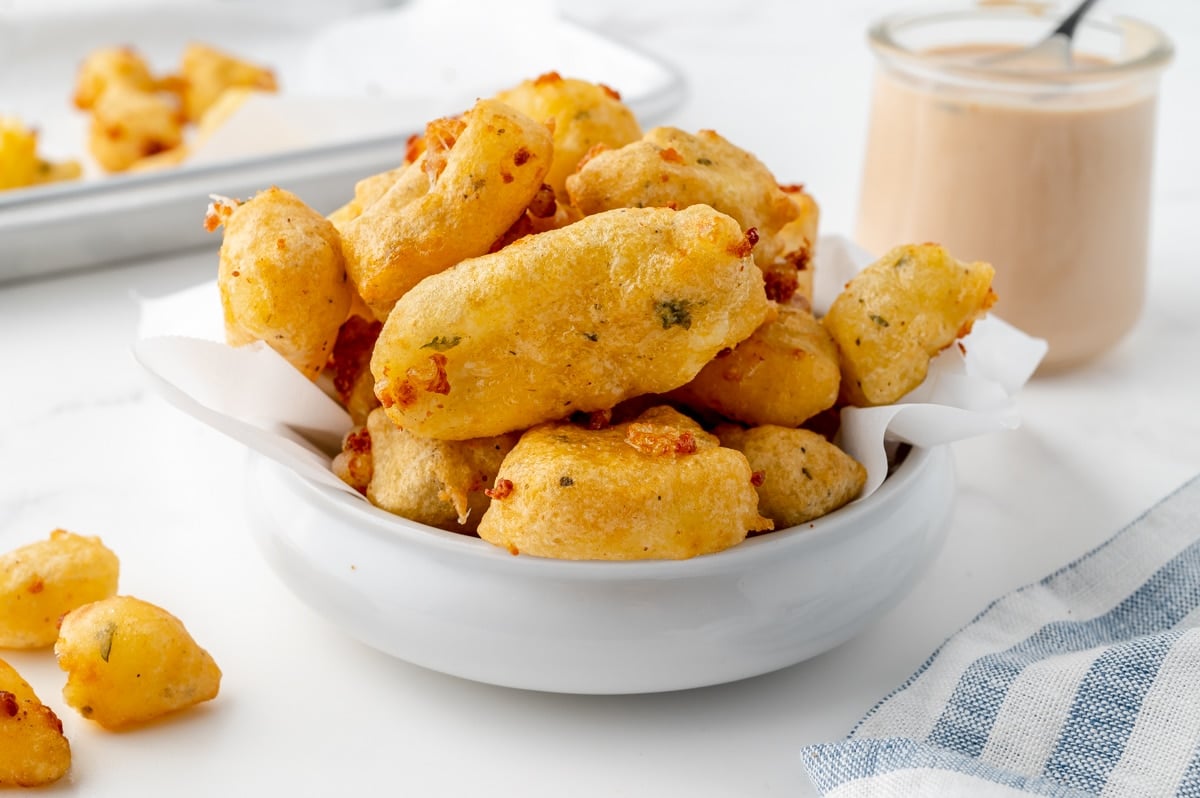 angled shot of bowl of crispy cheese curds