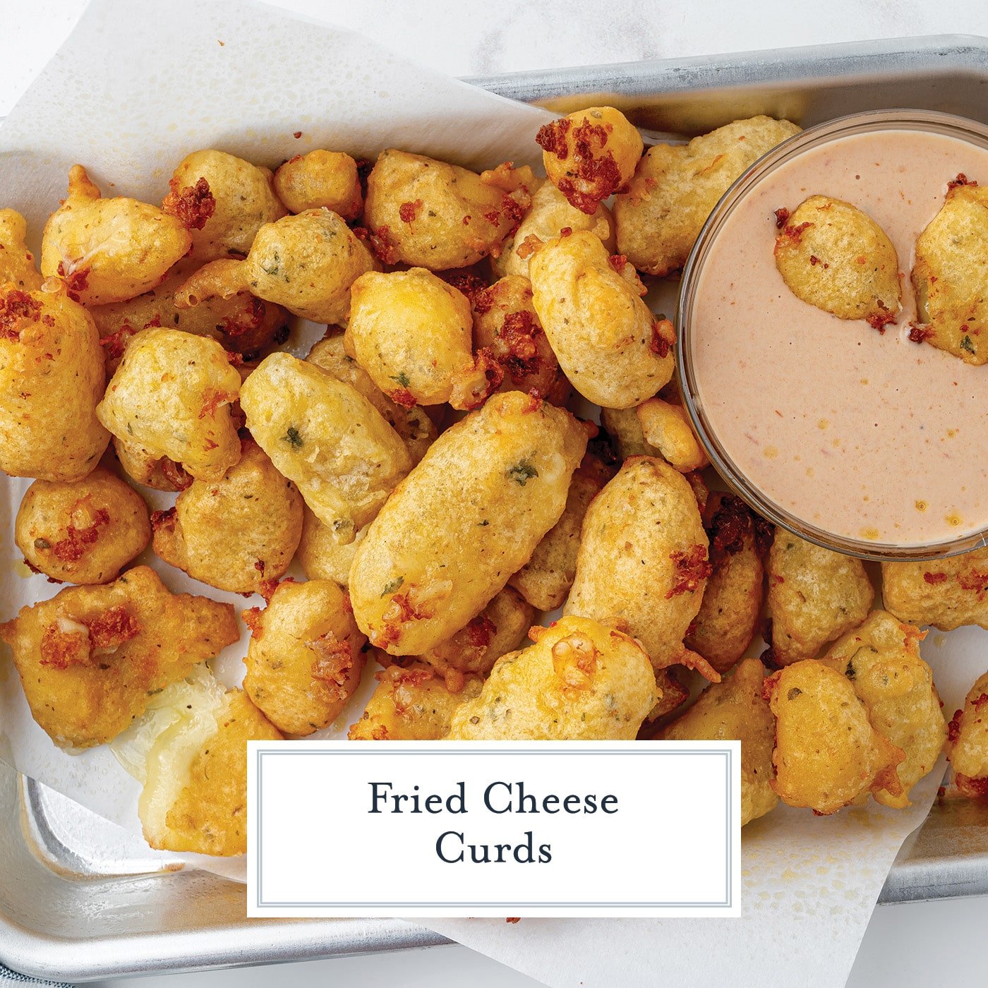 overhead shot of tray of fried cheese curds with dipping sauce with text overlay for facebook