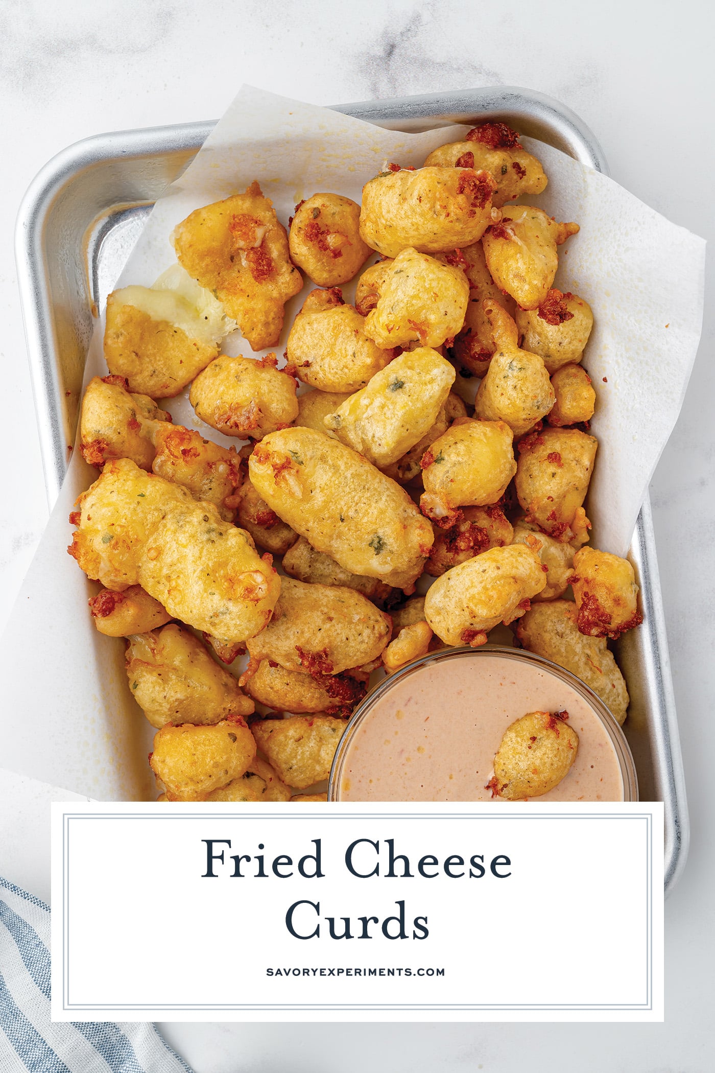 angled tray of cheese curds with text overlay for pinterest