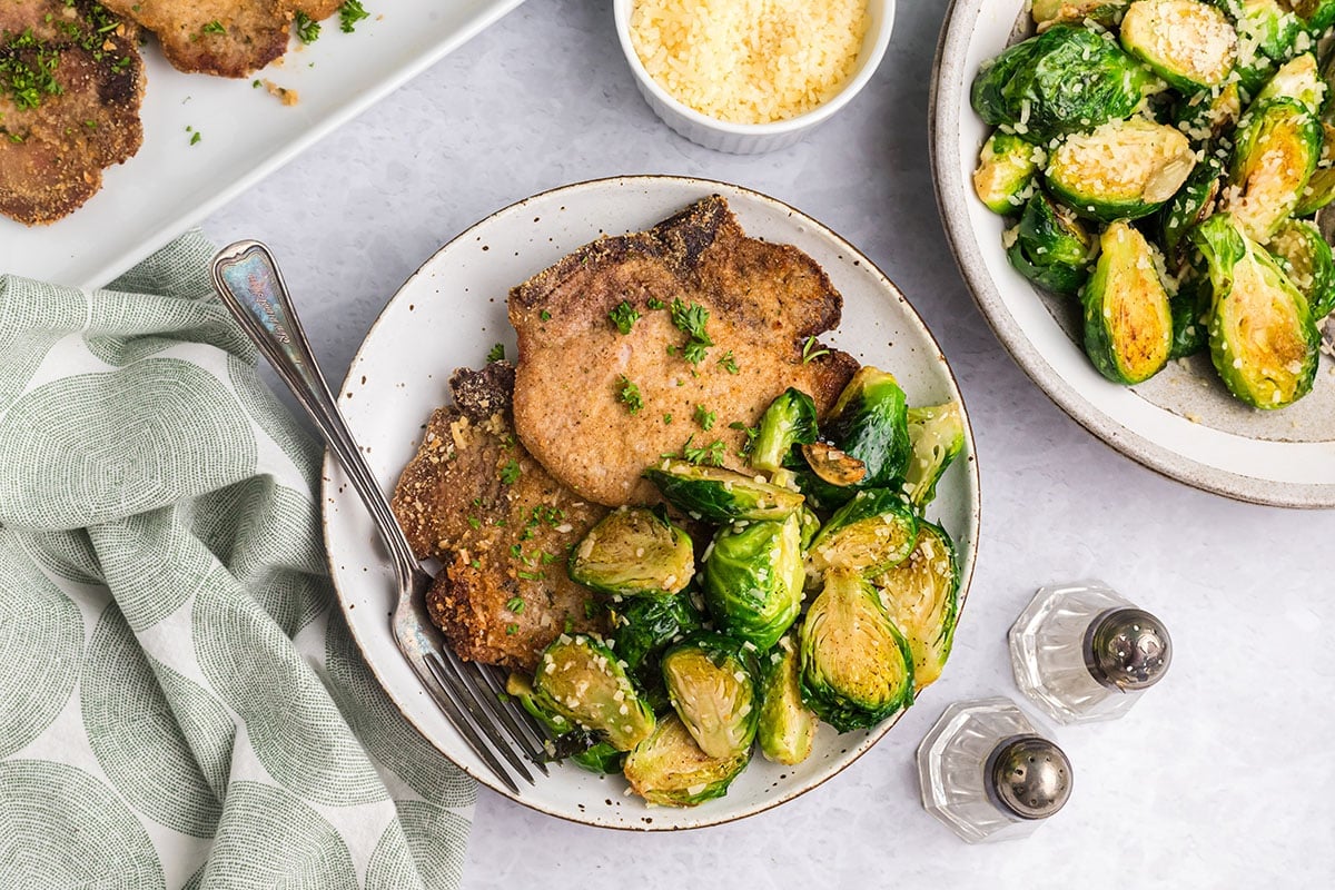 overhead shot of plate of pork with brussels sprouts