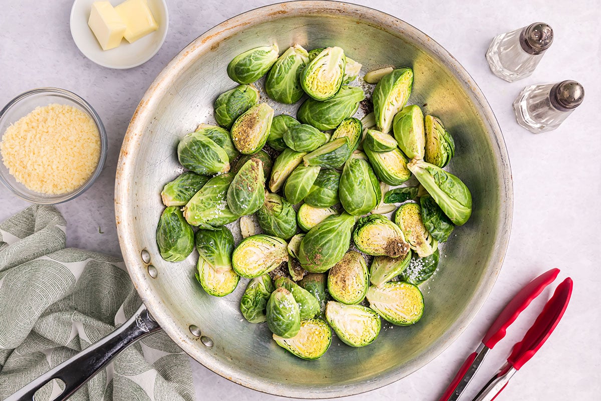 seasonings added to pan with brussels sprouts