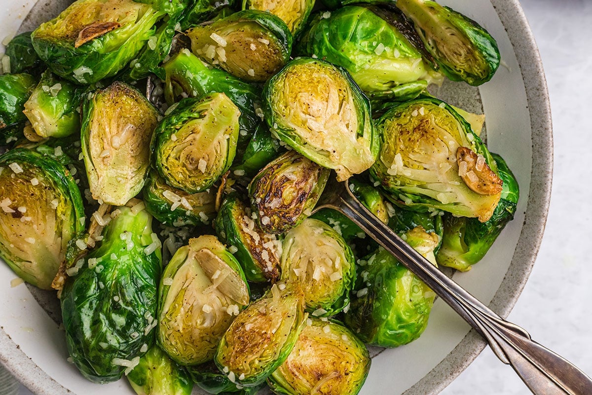 close up overhead shot of bowl of garlic butter brussels sprouts