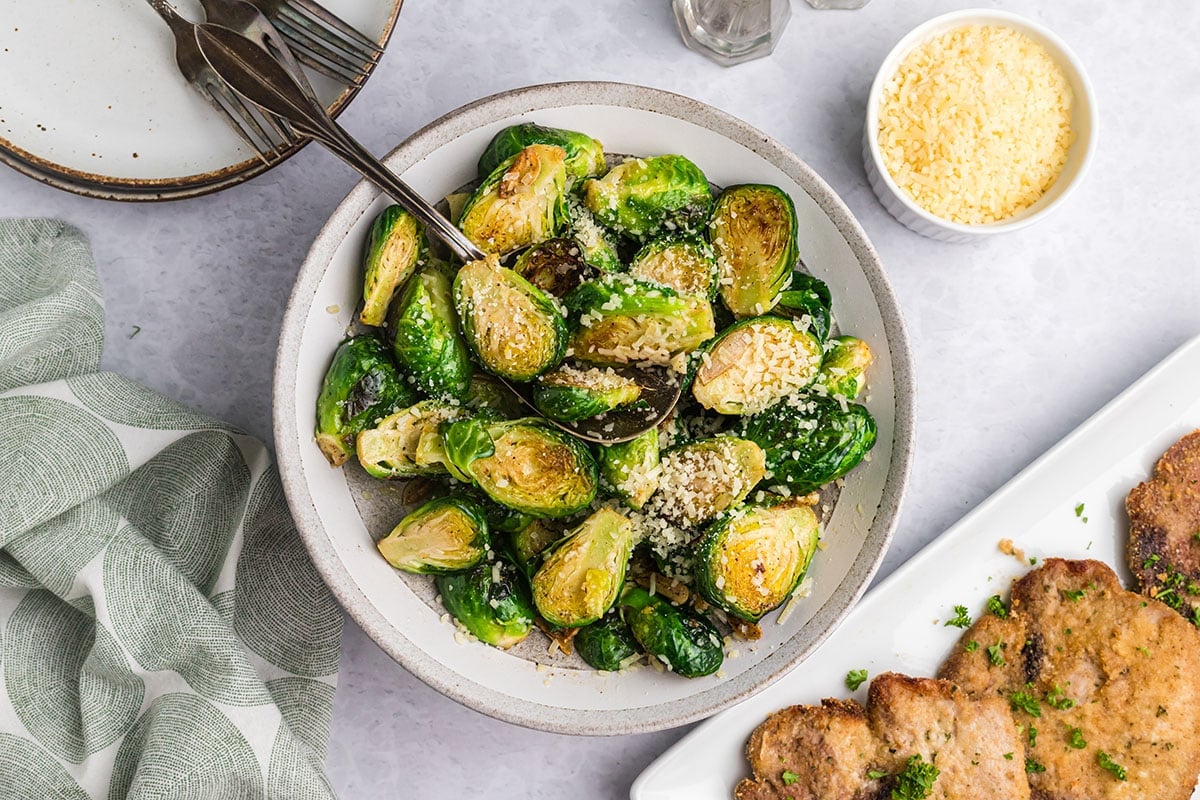 serving spoon in bowl of garlic butter brussels sprouts