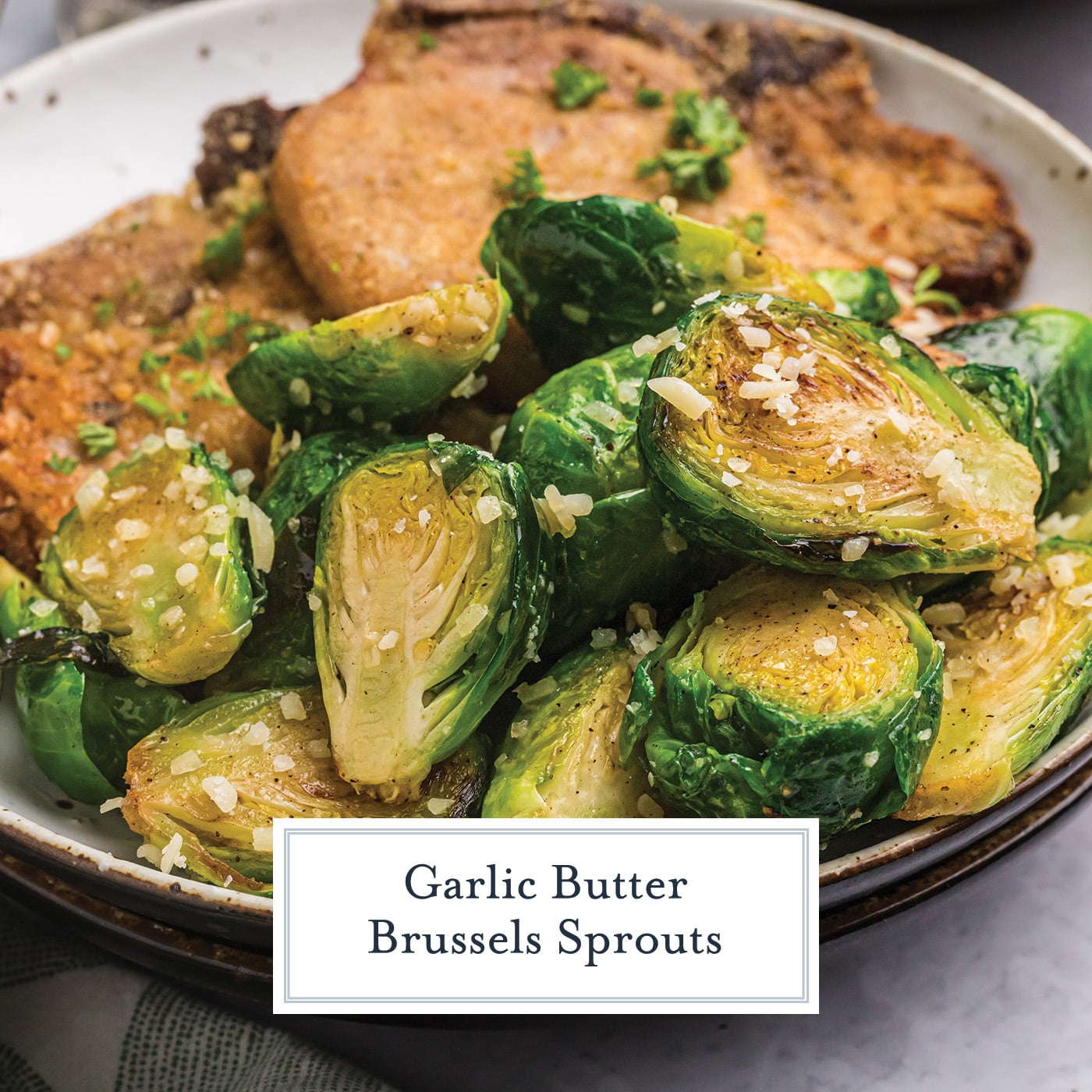 angled shot of garlic butter brussels sprouts on plate with pork with text overlay for facebook