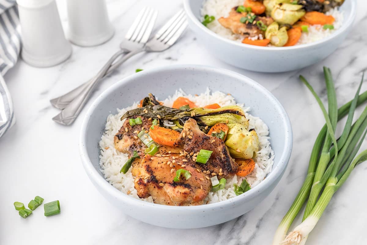 angled shot of bowl of honey garlic chicken with rice