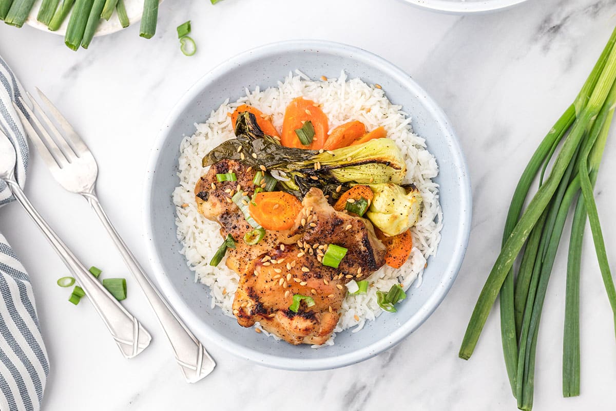 overhead shot of bowl of chicken, veggies and rice