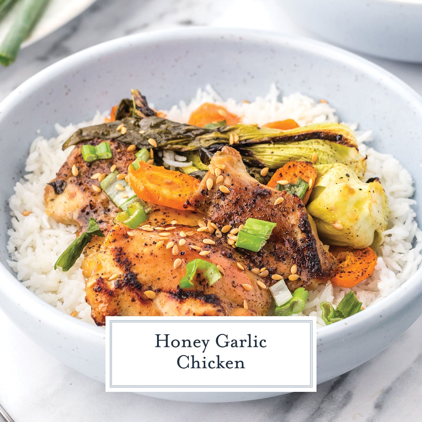 angled shot of bowl of honey garlic chicken with text overlay for facebook