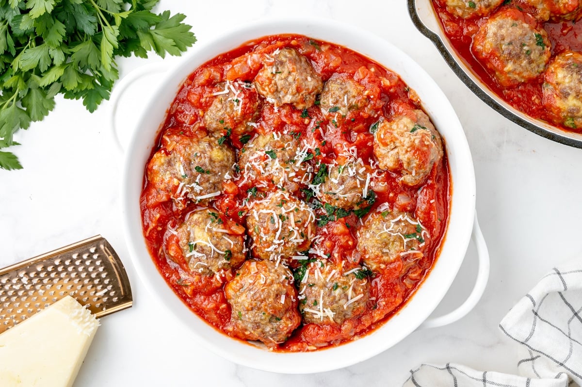 overhead of meatballs in sauce in a serving bowl