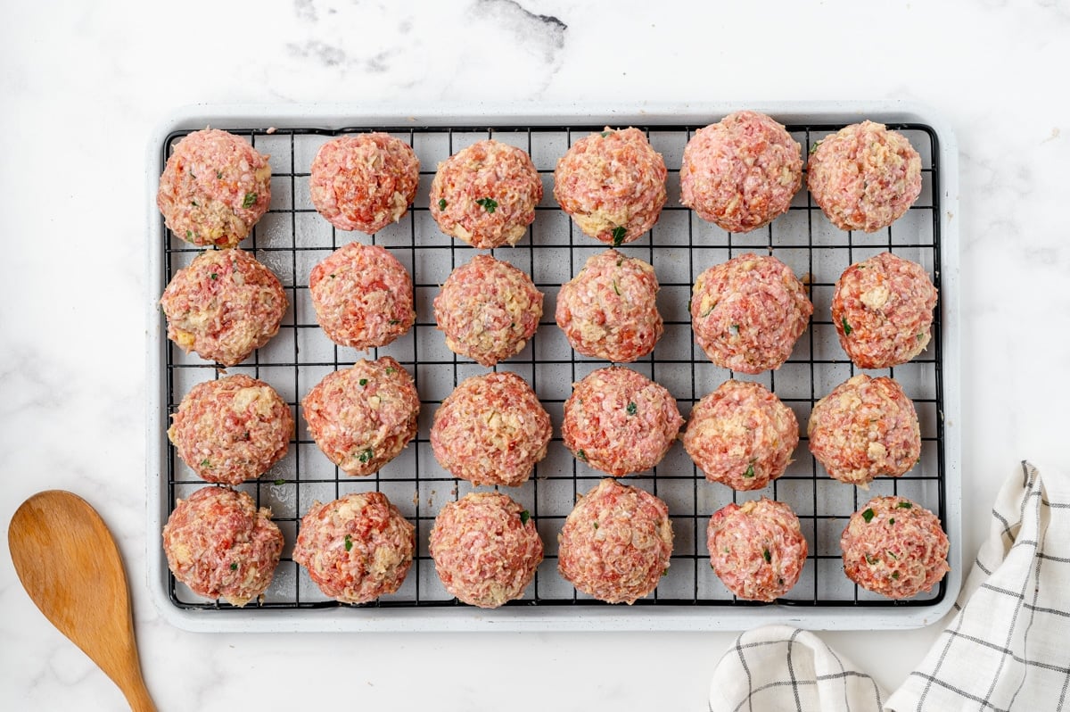 raw meatballs on a baking sheet