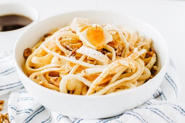 syrup poured on top of breakfast spaghetti