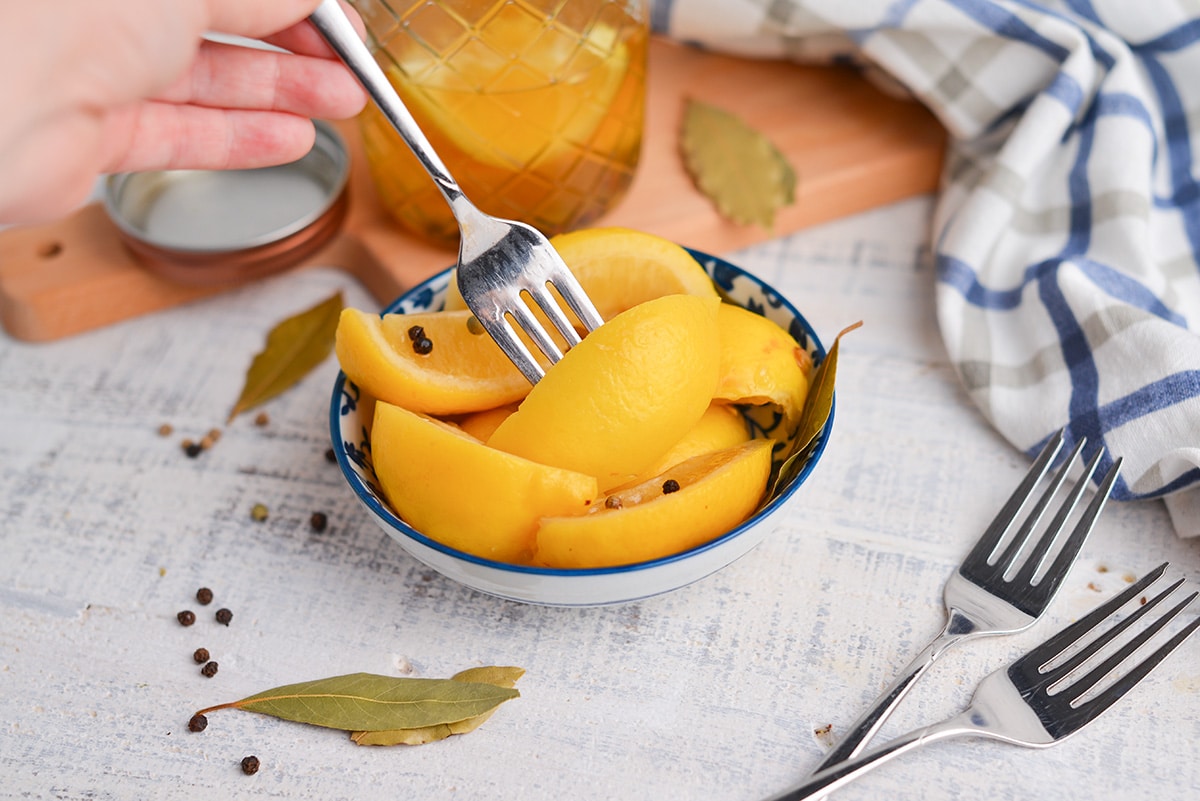 fork grabbing lemon from bowl